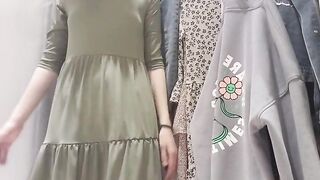 Russian Sudent trying on a Dress in a Fitting Room