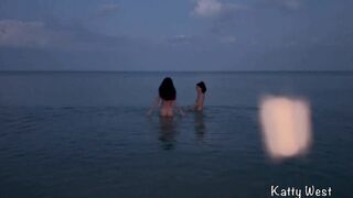 Two naked sluts swimming in the sea on a public beach