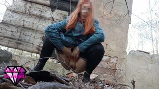 Desperate Redhead peeing in the forest ruins.