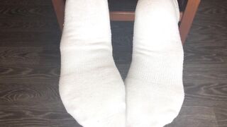 STUDENT GIRL SHOWS WHITE SOCKS AND FEET AFTER STUDYING.