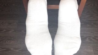 STUDENT GIRL SHOWS WHITE SOCKS AND FEET AFTER STUDYING.