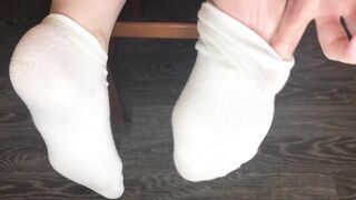 STUDENT GIRL SHOWS WHITE SOCKS AND FEET AFTER STUDYING.