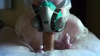 woman in a gas mask and gloves jerks off a cock and sucks. Handjob, blowjob