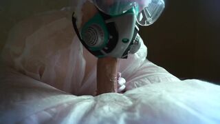 woman in a gas mask and gloves jerks off a cock and sucks. Handjob, blowjob