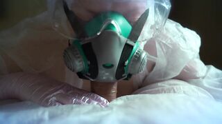 woman in a gas mask and gloves jerks off a cock and sucks. Handjob, blowjob