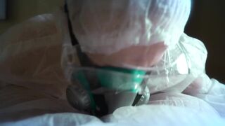 woman in a gas mask and gloves jerks off a cock and sucks. Handjob, blowjob