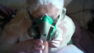 woman in a gas mask and gloves jerks off a cock and sucks. Handjob, blowjob