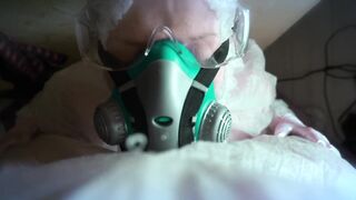 woman in a gas mask and gloves jerks off a cock and sucks. Handjob, blowjob