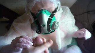 woman in a gas mask and gloves jerks off a cock and sucks. Handjob, blowjob