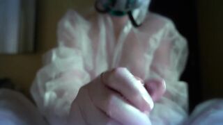 woman in a gas mask and gloves jerks off a cock and sucks. Handjob, blowjob