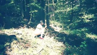 Beautiful slut totally naked in the forest sucking a dildo