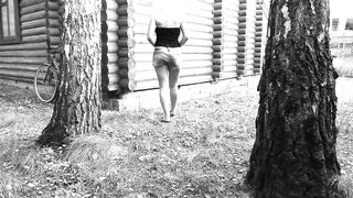 Slim big booty MILF peeing in a secluded outdoor spot.