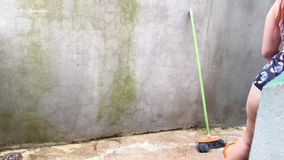 Maid in pajamas cleaning the yard