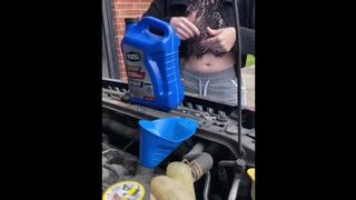 Girl fills oil up in her car and flashes tits