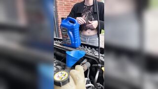 Girl fills oil up in her car and flashes tits