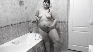 Pissing mature bbw milf with hairy pussy standing in the bathroom.