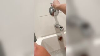 Solo girl with perky tits cums in bath from shower head