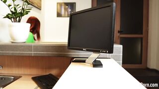 Fucking a redhead behind her working desk