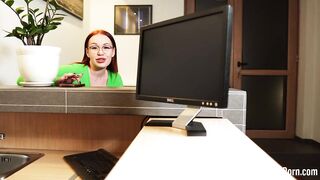 Fucking a redhead behind her working desk