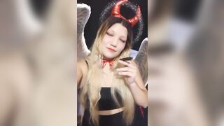 Angel of hell. Halloween costume. Cute girls smoke with me